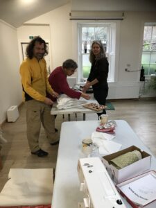 The team cutting and sewing